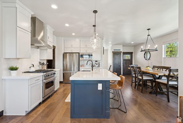 14482 N Buck Horn Trl Unit 50A, Heber City, UT 84032 - kitchen with appliances with stainless steel finishes, wall chimney exhaust hood, light countertops, backsplash, and recessed lighting