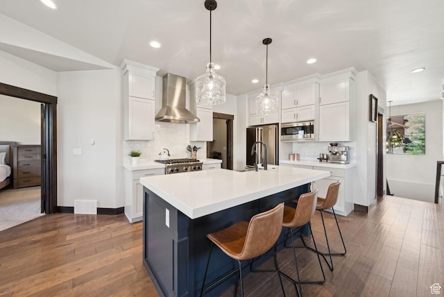 14482 N Buck Horn Trl Unit 50A, Heber City, UT 84032 - kitchen with wall chimney exhaust hood, appliances with stainless steel finishes, wood finished floors, light countertops, and backsplash