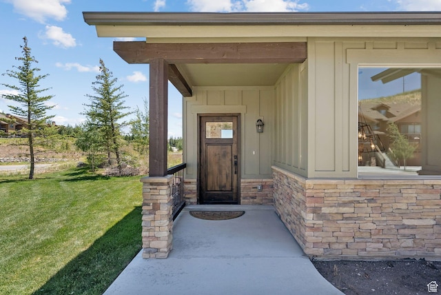 14482 N Buck Horn Trl Unit 50A, Heber City, UT 84032 - view of exterior entry with board and batten siding and a yard