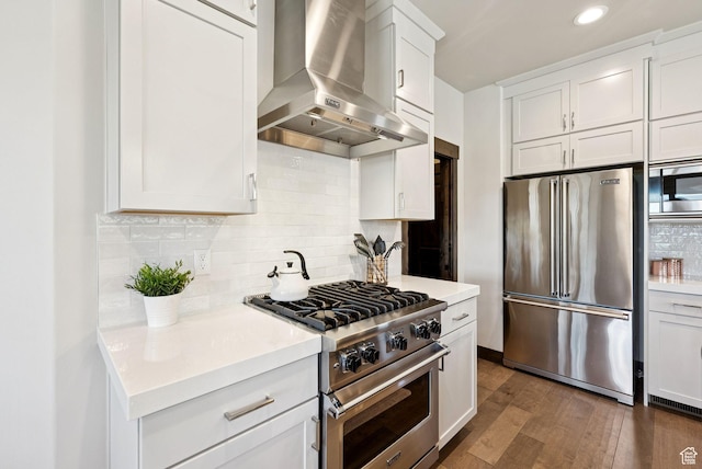 14482 N Buck Horn Trl Unit 50A, Heber City, UT 84032 - kitchen featuring high quality appliances, wall chimney range hood, dark wood-style flooring, light countertops, and recessed lighting