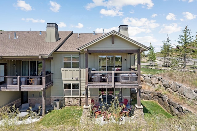 14482 N Buck Horn Trl Unit 50A, Heber City, UT 84032 - rear view of property featuring a chimney, board and batten siding, stone siding, and roof with shingles
