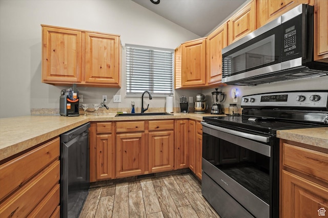 2371 N 1110 W, Clinton, UT 84015 - kitchen with stainless steel appliances, vaulted ceiling, light countertops, and light wood finished floors