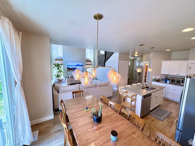 933 S 2100 W, Orem, UT 84059 - dining space featuring light wood finished floors, a textured ceiling, recessed lighting, and stairway