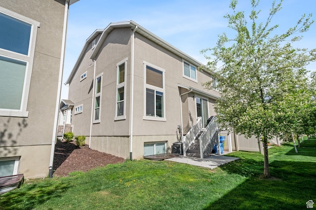933 S 2100 W, Orem, UT 84059 - rear view of property featuring a lawn, stucco siding, and stairs