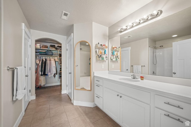933 S 2100 W, Orem, UT 84059 - full bath with vanity, a spacious closet, tile patterned floors, a shower, and a textured ceiling
