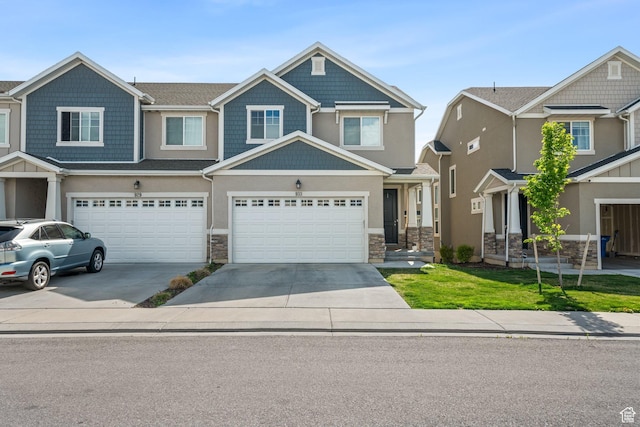 933 S 2100 W, Orem, UT 84059 - craftsman-style house featuring driveway, stone siding, and an attached garage