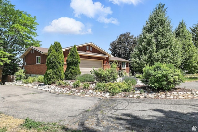 80 S 6000 W, Mendon, UT 84325 - view of front facade featuring a garage, brick siding, and driveway