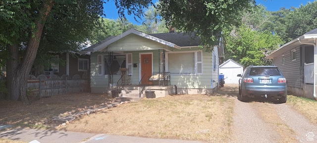 968 S Jeffreson, Ogden, UT 84404 - bungalow-style house featuring dirt driveway, covered porch, and an outbuilding