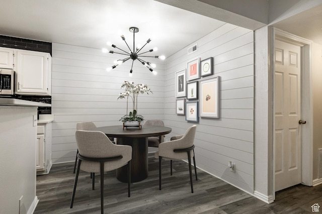 650 S Main St Unit 3102, Bountiful, UT 84010 - dining space featuring a chandelier, dark wood-type flooring, and wood walls