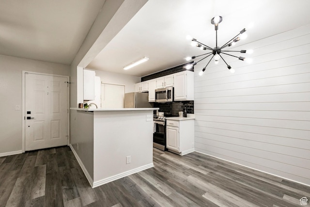 650 S Main St Unit 3102, Bountiful, UT 84010 - kitchen featuring stainless steel appliances, a chandelier, dark wood-type flooring, backsplash, and white cabinets