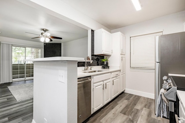 650 S Main St Unit 3102, Bountiful, UT 84010 - kitchen featuring dishwasher, stove, wood finished floors, ceiling fan, and white cabinetry
