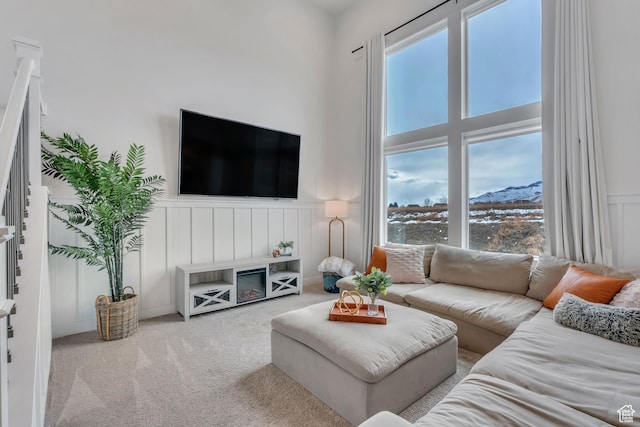 1769 W Stone Gate Dr, Saratoga Springs, UT 84045 - carpeted living room with a wainscoted wall, a decorative wall, and a high ceiling
