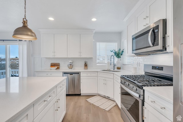 1769 W Stone Gate Dr, Saratoga Springs, UT 84045 - kitchen featuring appliances with stainless steel finishes, plenty of natural light, tasteful backsplash, light countertops, and recessed lighting