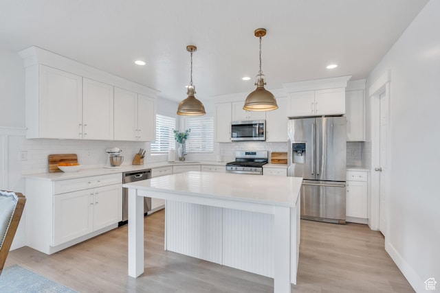 1769 W Stone Gate Dr, Saratoga Springs, UT 84045 - kitchen with appliances with stainless steel finishes, decorative backsplash, light countertops, white cabinets, and recessed lighting