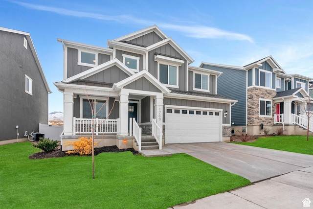 1769 W Stone Gate Dr, Saratoga Springs, UT 84045 - craftsman house with board and batten siding, stone siding, a porch, a garage, and concrete driveway