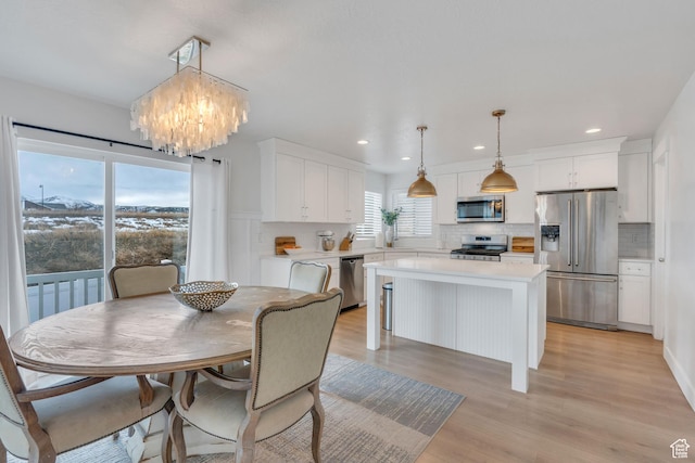 1769 W Stone Gate Dr, Saratoga Springs, UT 84045 - dining area with recessed lighting, a chandelier, and light wood-style flooring