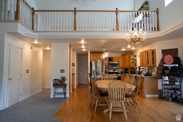 398 E Wells Fargo Rd, Brookside, UT 84782 - dining space with a high ceiling, a chandelier, and light wood-type flooring