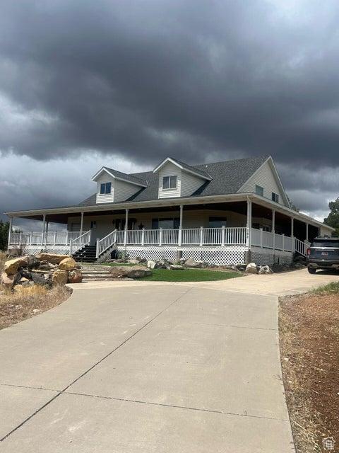 398 E Wells Fargo Rd, Brookside, UT 84782 - country-style home featuring a porch and driveway