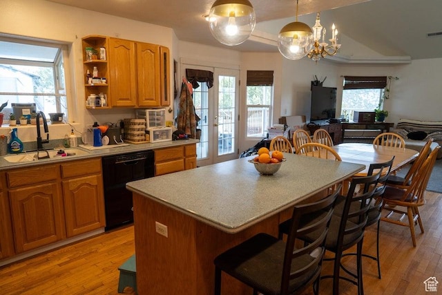 398 E Wells Fargo Rd, Brookside, UT 84782 - kitchen with black dishwasher, light wood-style flooring, light countertops, a kitchen island, and a kitchen bar