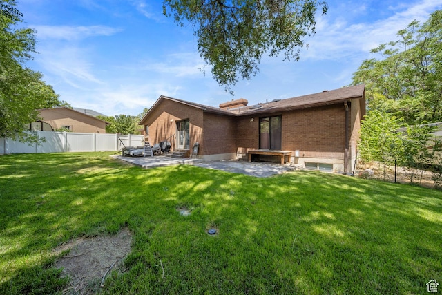 5350 S Jordan Canal Rd, Salt Lake City, UT 84129 - back of house with brick siding and a patio