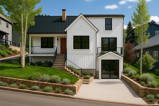 1003 Norfolk Ave, Park City, UT 84060 - view of front facade featuring stairway, a chimney, concrete driveway, a standing seam roof, and a garage