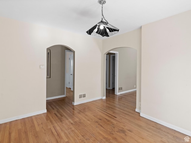 1740 E Harrison Ave, Salt Lake City, UT 84108 - unfurnished room with arched walkways and light wood-style flooring