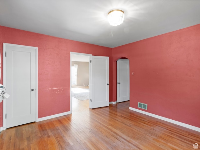 1740 E Harrison Ave, Salt Lake City, UT 84108 - empty room featuring arched walkways and light wood-style floors