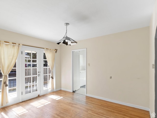 1740 E Harrison Ave, Salt Lake City, UT 84108 - unfurnished dining area with french doors and light wood-style floors