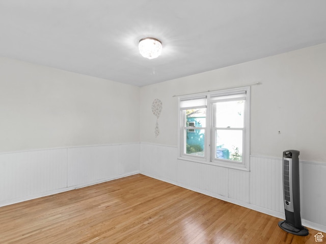 1740 E Harrison Ave, Salt Lake City, UT 84108 - empty room featuring a wainscoted wall and light wood-type flooring