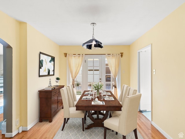 1740 E Harrison Ave, Salt Lake City, UT 84108 - dining room with light wood-style floors, arched walkways, and french doors