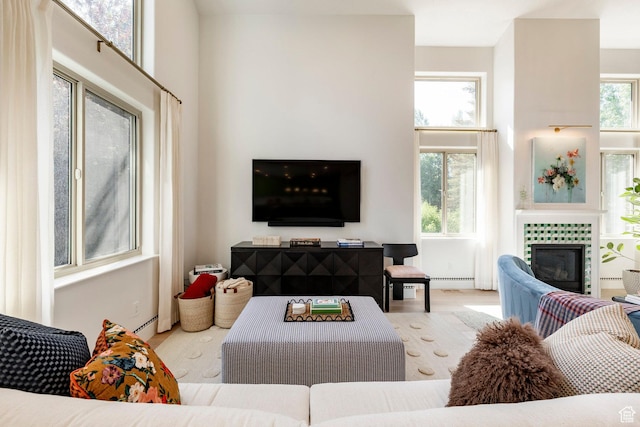 1675 W Silver Springs Rd, Park City, UT 84098 - living room with wood finished floors, a tile fireplace, and a baseboard radiator