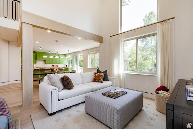 1675 W Silver Springs Rd, Park City, UT 84098 - living room with light wood finished floors, a baseboard radiator, recessed lighting, and a high ceiling