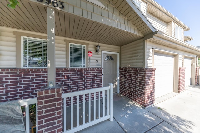 3963 S 2900 W Unit 2B, West Haven, UT 84401 - doorway to property with brick siding, covered porch, and concrete driveway