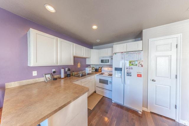 3963 S 2900 W Unit 2B, West Haven, UT 84401 - kitchen with white appliances, a peninsula, white cabinetry, dark wood-style floors, and light countertops