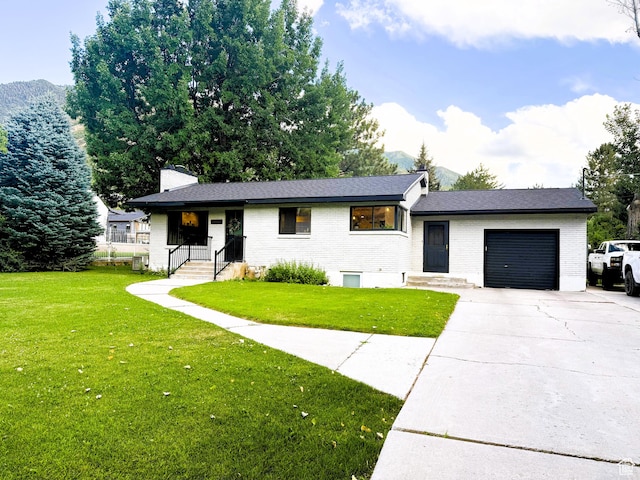 1990 E 400 N, Mapleton, UT 84664 - split level home with brick siding, a garage, driveway, and a front lawn
