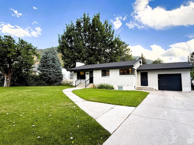 1990 E 400 N, Mapleton, UT 84664 - view of front facade featuring an attached garage, a front yard, driveway, and brick siding