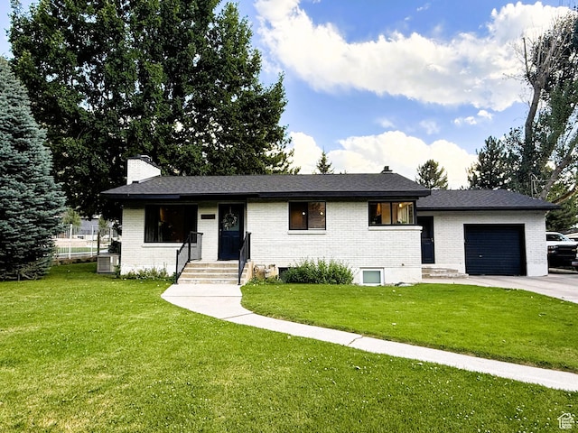 1990 E 400 N, Mapleton, UT 84664 - view of front of house featuring a chimney, an attached garage, brick siding, and a front lawn