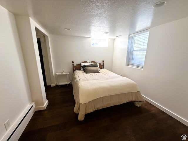 1990 E 400 N, Mapleton, UT 84664 - bedroom with baseboard heating, wood finished floors, and a textured ceiling