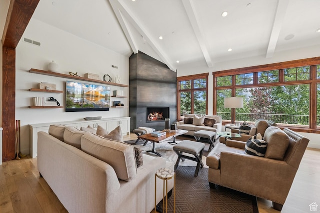9388 Dye Cabins Dr, Park City, UT 84098 - living room featuring light wood finished floors, beamed ceiling, a large fireplace, high vaulted ceiling, and recessed lighting