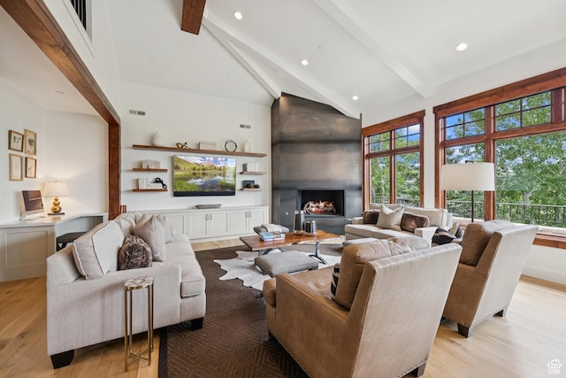9388 Dye Cabins Dr, Park City, UT 84098 - living area featuring high vaulted ceiling, light wood-type flooring, beamed ceiling, recessed lighting, and a lit fireplace