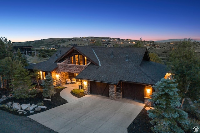 9388 Dye Cabins Dr, Park City, UT 84098 - view of front facade featuring stone siding, driveway, and a garage