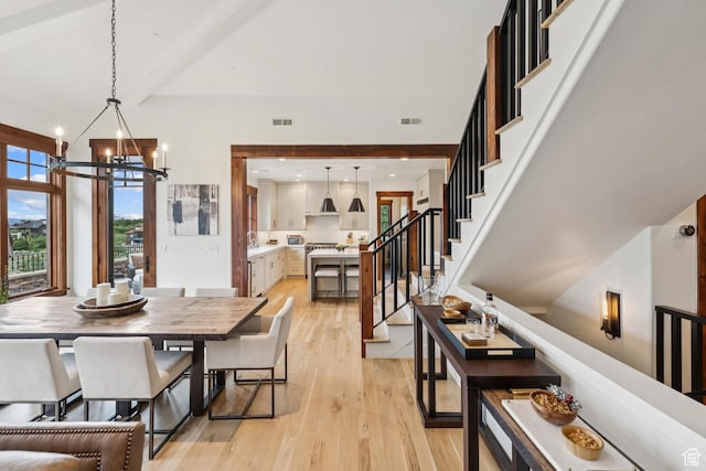 9388 Dye Cabins Dr, Park City, UT 84098 - dining area with light wood-type flooring, a chandelier, stairs, and beamed ceiling