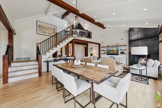 9388 Dye Cabins Dr, Park City, UT 84098 - dining area featuring light wood-type flooring, stairs, beamed ceiling, high vaulted ceiling, and a large fireplace