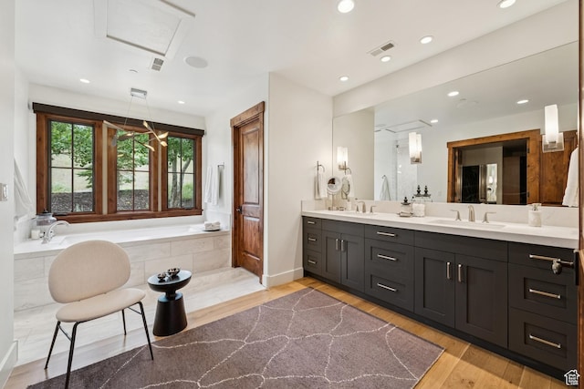 9388 Dye Cabins Dr, Park City, UT 84098 - full bathroom featuring a garden tub, double vanity, wood finished floors, and recessed lighting