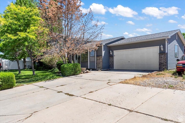 4970 S 4150 W, Roy, UT 84067 - view of front of house featuring brick siding, an attached garage, driveway, and a front lawn