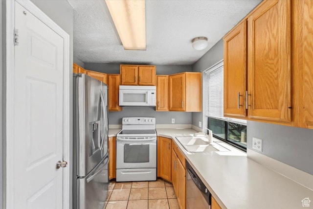 4970 S 4150 W, Roy, UT 84067 - kitchen with stainless steel appliances, light countertops, a textured ceiling, light tile patterned flooring, and brown cabinets