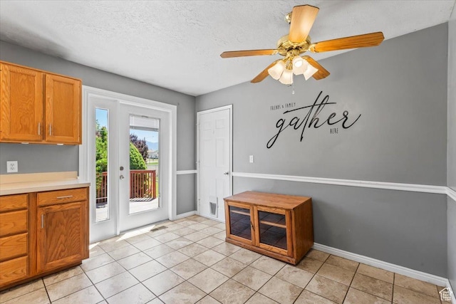 4970 S 4150 W, Roy, UT 84067 - unfurnished dining area with a ceiling fan, light tile patterned floors, and a textured ceiling
