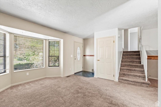 4970 S 4150 W, Roy, UT 84067 - unfurnished living room with carpet, stairs, and a textured ceiling