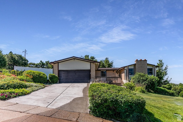 342 E State St, Farmington, UT 84025 - view of front of property featuring a garage, brick siding, and concrete driveway