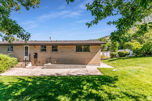 342 E State St, Farmington, UT 84025 - rear view of property with a patio, a yard, and brick siding